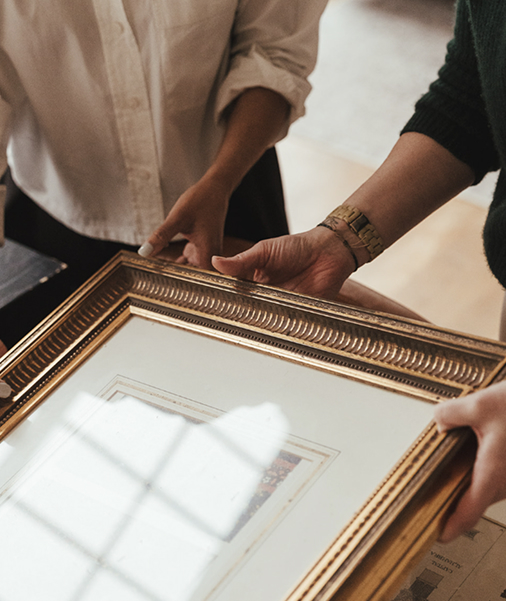 Picture of antique frame being held by two people